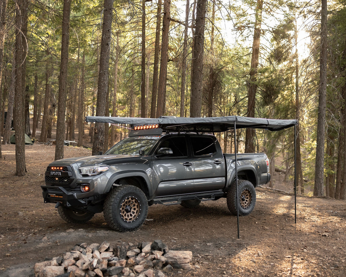 Taruca Rogue 180 awning deployed freestanding with support legs in forest camp