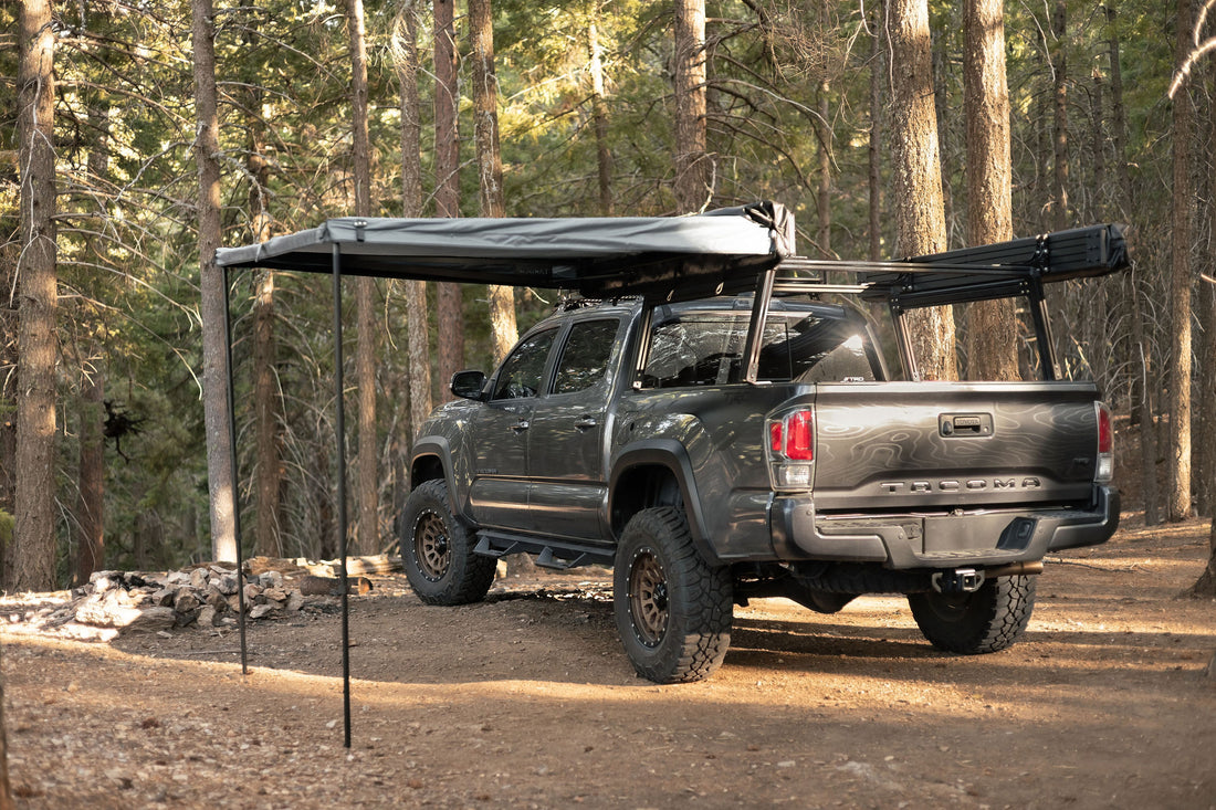 Taruca Rogue 6FT awning deployed with a support leg in a forest camp