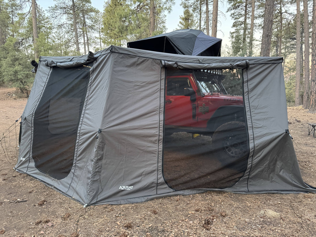 Grey wall kit with mesh windows on a vehicle in a forest