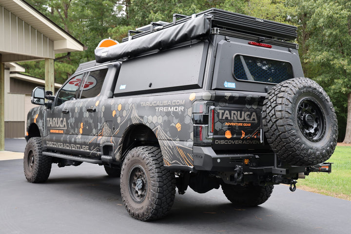 Taruca Rogue 270 S awning packed on the roof rack, rear three-quarter view of pickup