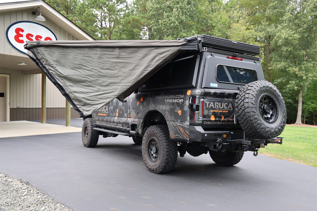 Taruca Rogue 270 S awning side panel half open during setup, rear view