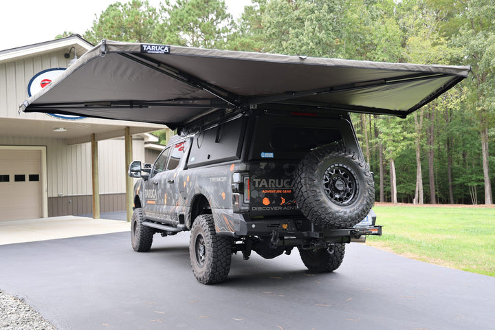 Taruca Rogue 270 S awning deployed around the side and rear of a pickup, rear view