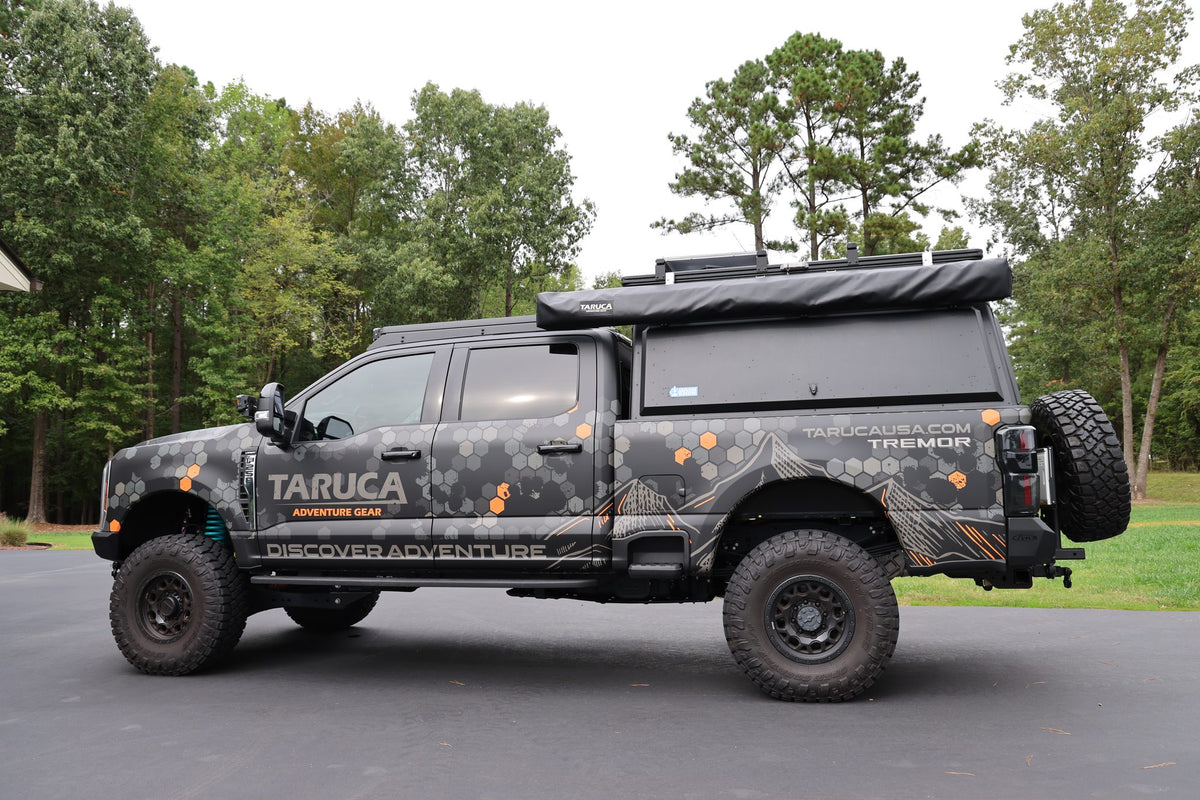 Taruca Rogue 270 S awning packed in its black cover on the driver side of a pickup, side profile
