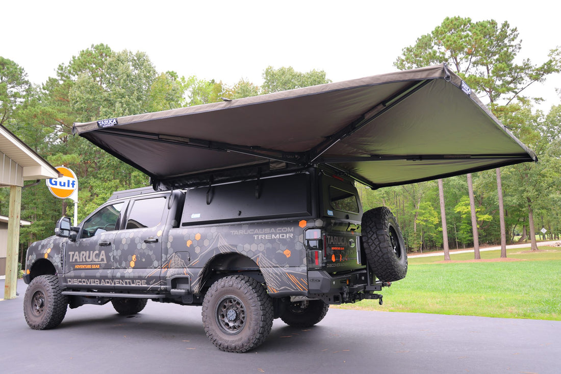Taruca Rogue 270 S awning fully deployed on the driver side of a wrapped pickup, front three-quarter view