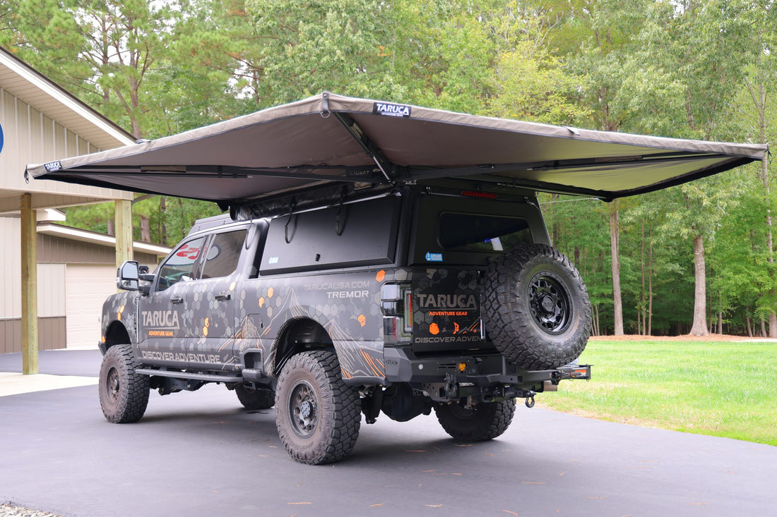 Taruca Rogue 270 S awning deployed and freestanding over the rear of a pickup, rear three-quarter view